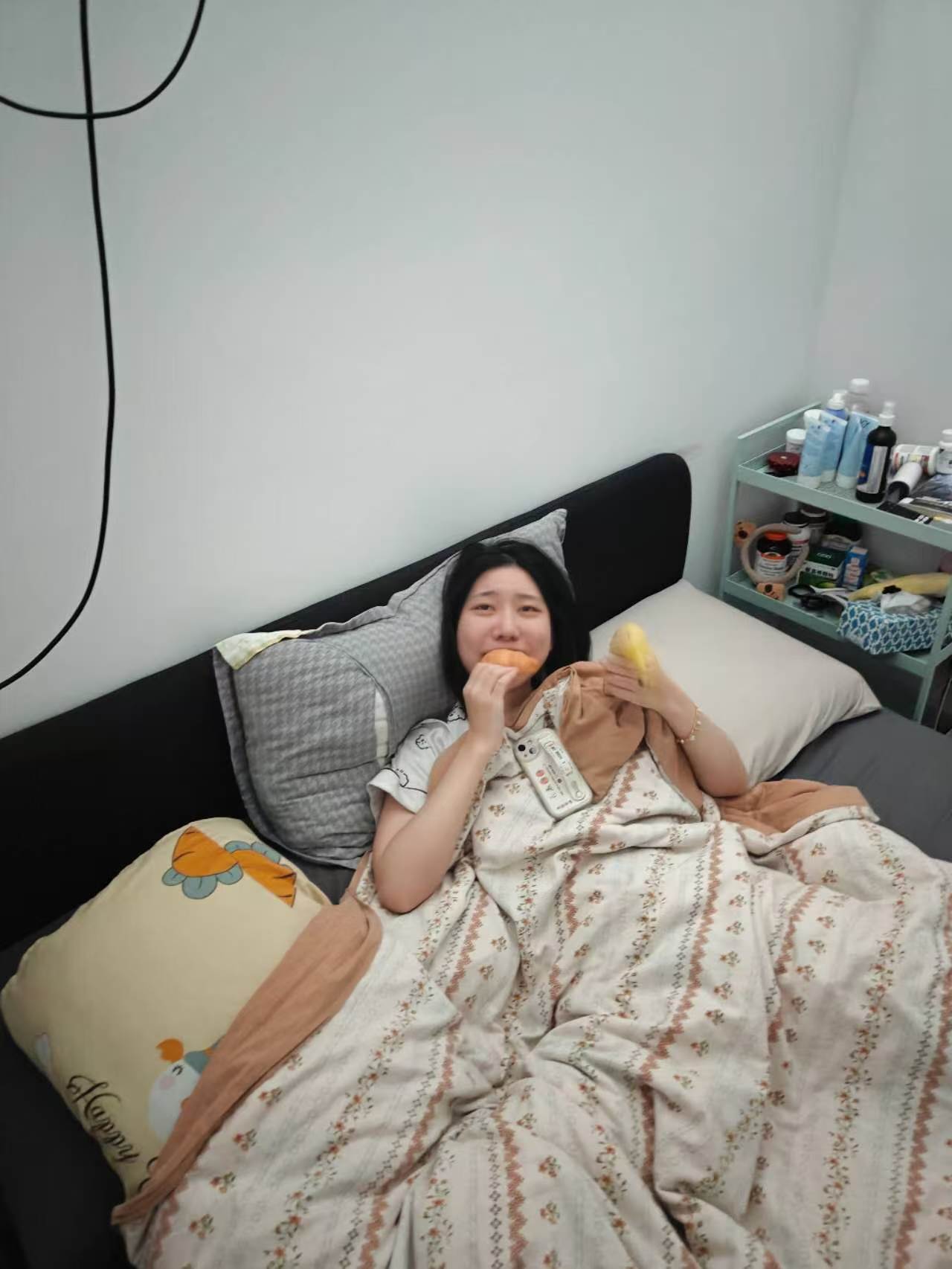 Nora eating snacks in bed